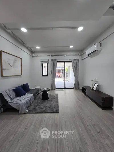 Spacious modern living room with sleek design and large windows for natural light.