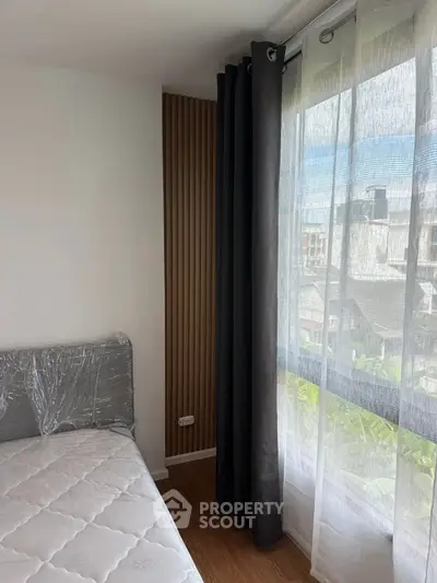 Cozy bedroom with large window and modern decor