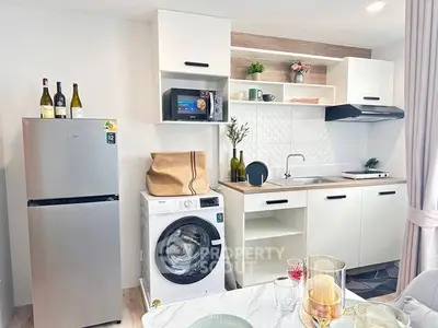 Modern kitchen with washing machine and fridge in stylish apartment