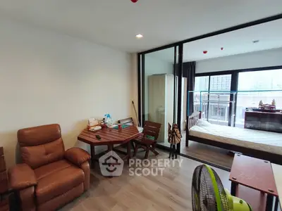 Modern studio apartment with cozy living area and large windows
