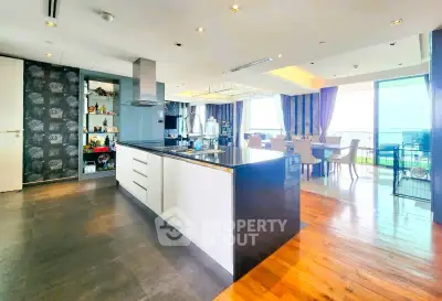 Luxurious open-plan kitchen and dining area with modern design and stunning views.