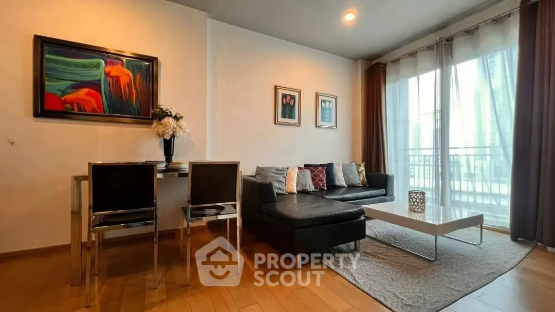 Modern living room with stylish decor and natural light, featuring a cozy seating area and elegant dining setup.