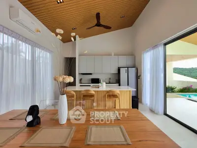 Modern open-plan kitchen and dining area with pool view