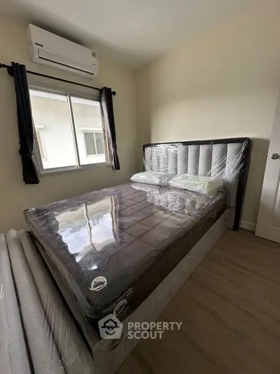 Cozy bedroom with new bed and air conditioning, perfect for restful nights.