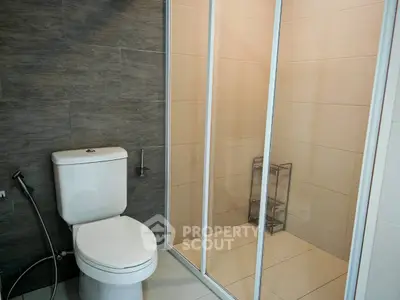 Modern bathroom with sleek shower and contemporary toilet design.