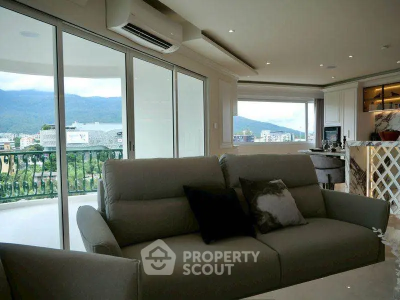 Luxurious living room with panoramic view and modern kitchen in open layout apartment.