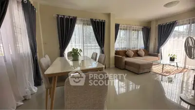 Spacious living room with elegant decor and large windows for natural light.