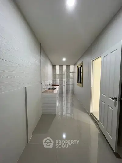 Modern minimalist kitchen with sleek tile flooring and open layout