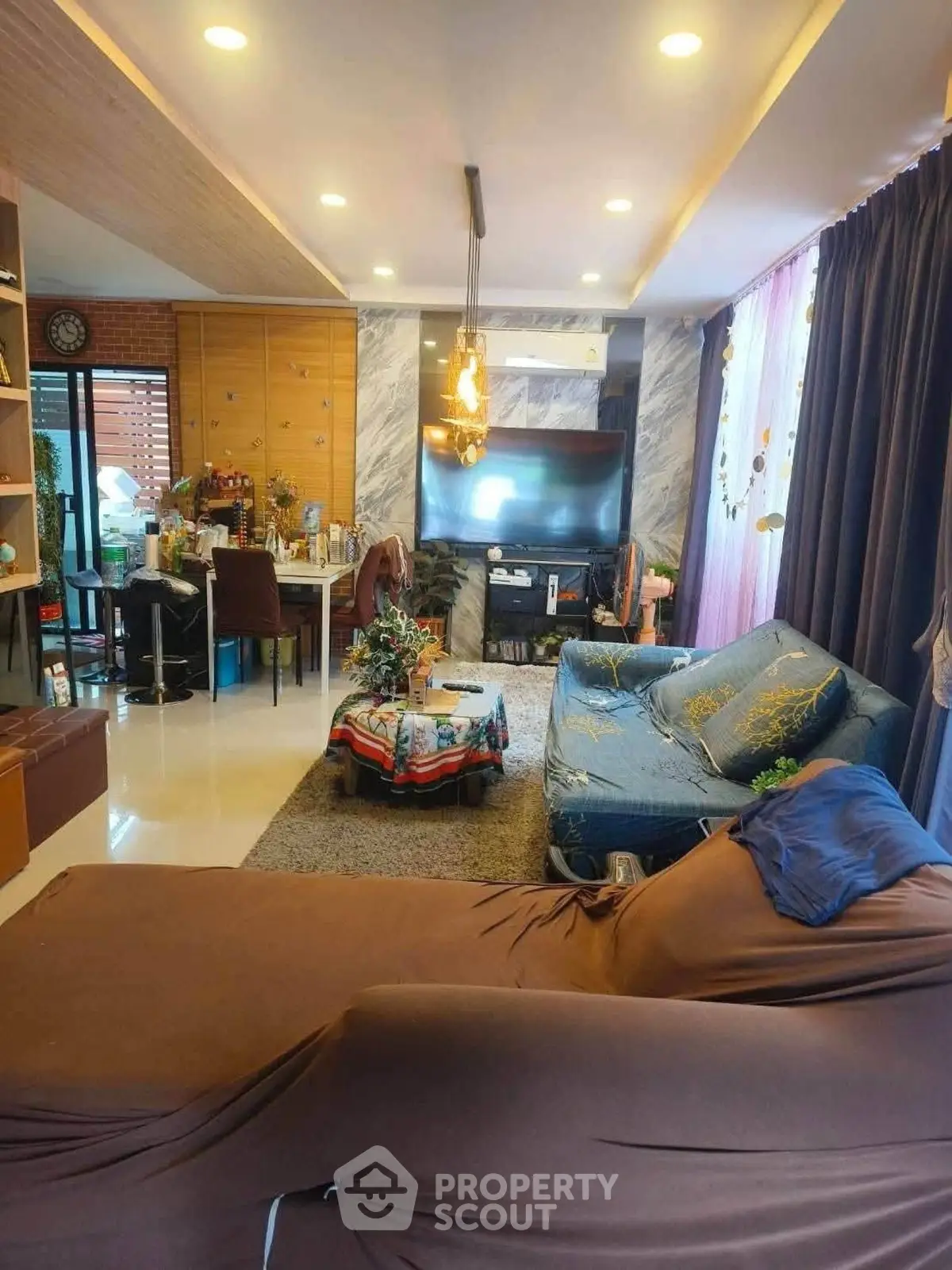 Spacious living room with modern decor and ample natural light, perfect for relaxation and entertainment.