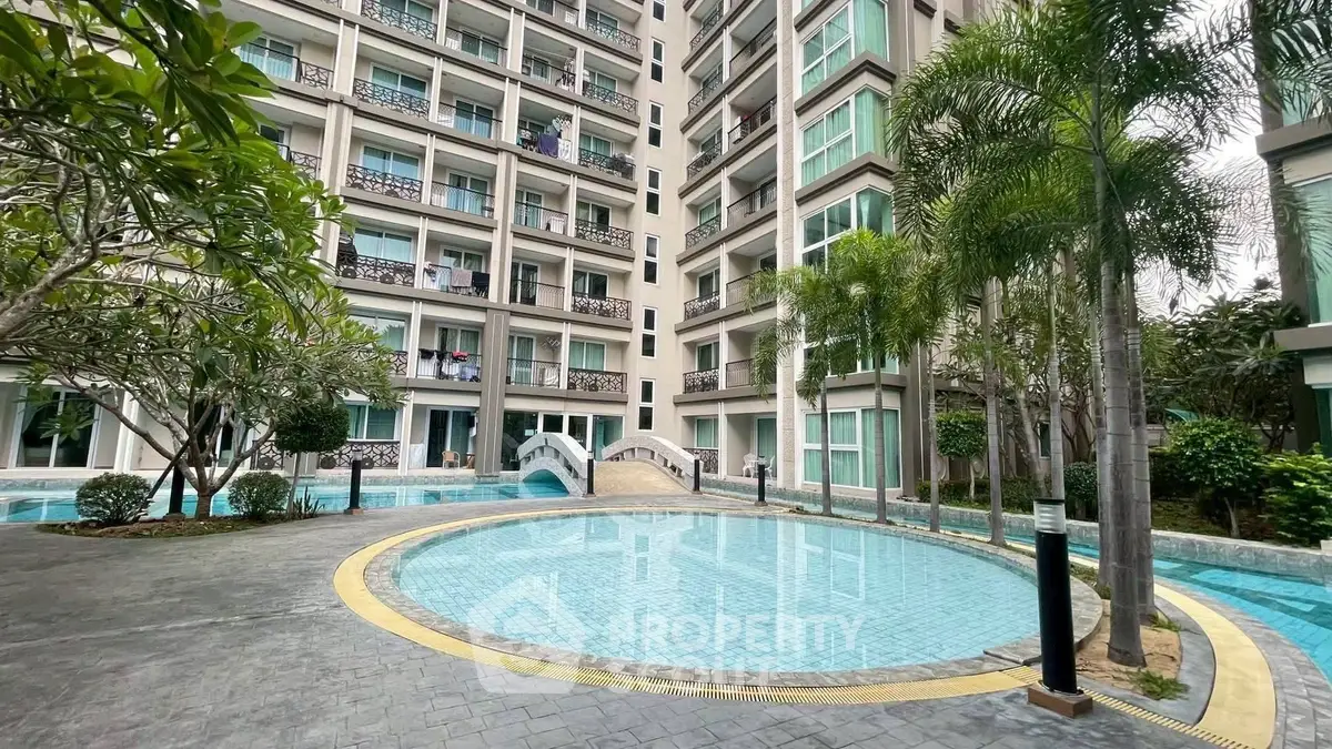 Luxurious condominium with stunning pool and lush greenery, perfect for modern living.
