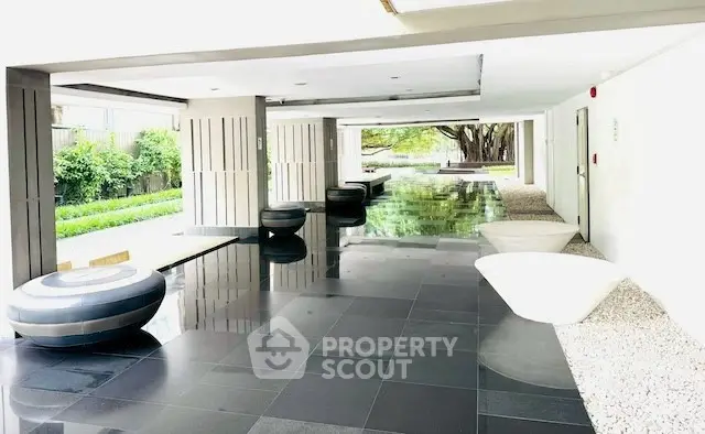 Modern building entrance with sleek design and reflective flooring