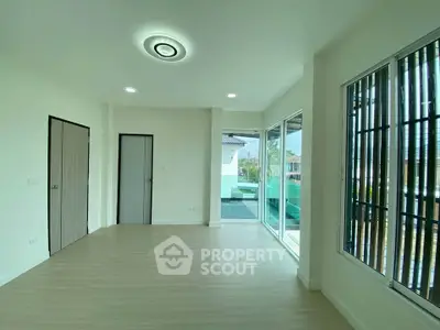 Spacious modern living room with large windows and pool view