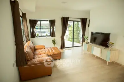 Spacious living room with modern decor and large windows for natural light