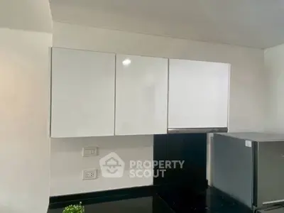 Modern kitchen with sleek white cabinets and stainless steel appliances