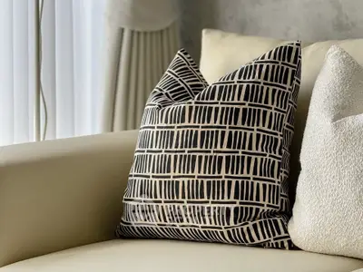 Stylish modern living room with elegant patterned cushions on a sleek beige sofa.
