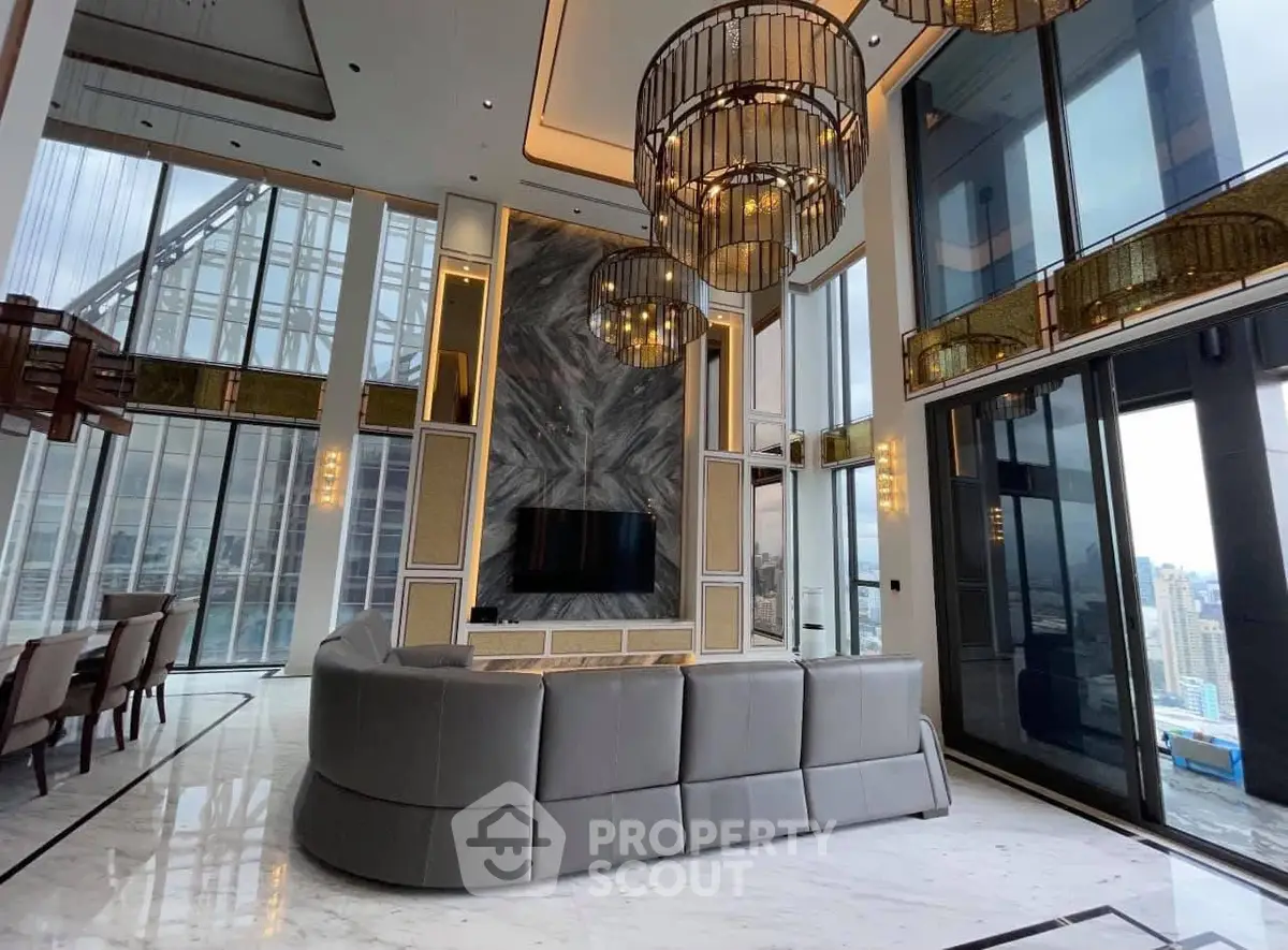 Luxurious high-rise living room with panoramic city views and elegant chandeliers.