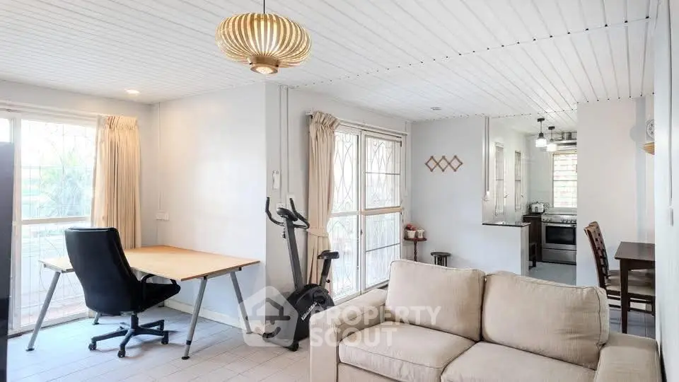 Spacious living room with modern decor and open kitchen layout