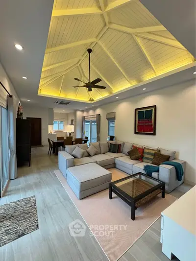 Spacious living room with modern decor and vaulted ceiling