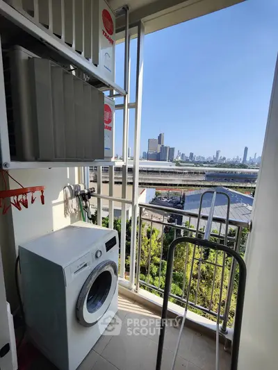 Charming balcony with city view and washing machine, perfect for urban living convenience.