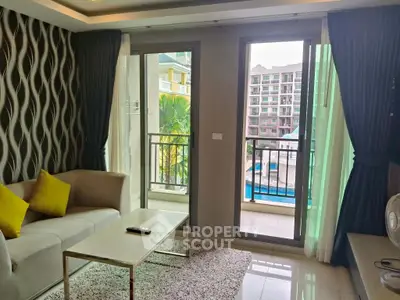 Modern living room with pool view and stylish decor in a high-rise apartment.