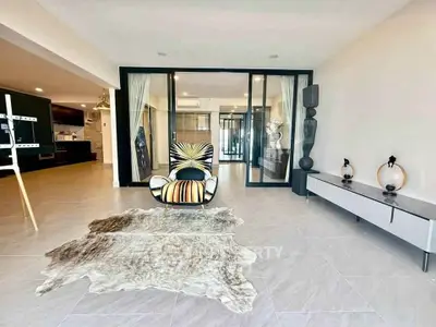 Spacious modern living room with stylish decor and open layout in luxury apartment.
