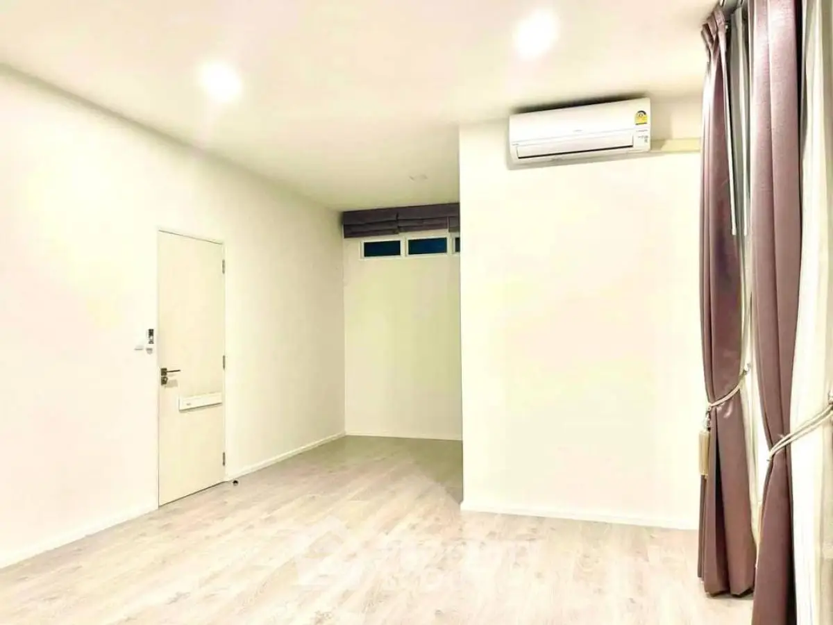 Spacious empty room with air conditioning and elegant curtains