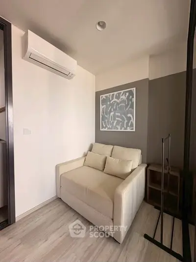 Cozy corner with modern sofa and air conditioning in stylish apartment