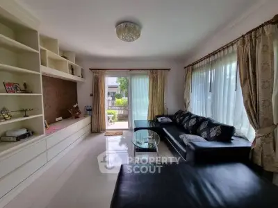 Spacious living room with elegant decor and large windows for natural light