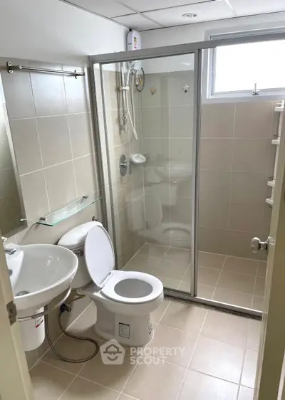 Modern bathroom with glass shower enclosure and sleek fixtures