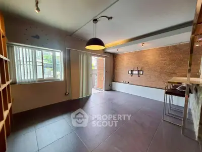 Spacious modern living room with large windows and stylish lighting in a contemporary home.