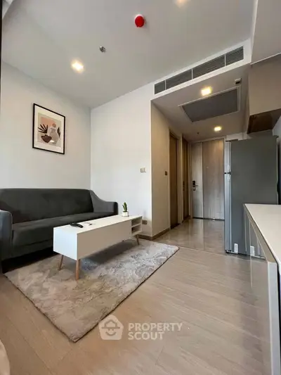 Modern living room with sleek furniture and stylish decor in a contemporary apartment.