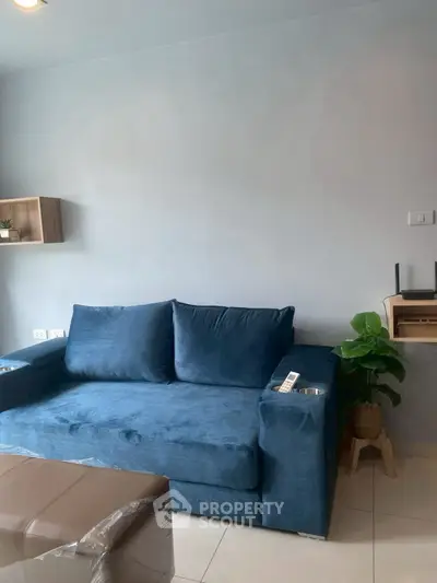 Modern living room with blue sofa and minimalist decor