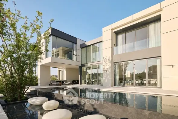 Luxurious modern home with sleek architecture and stunning poolside view.