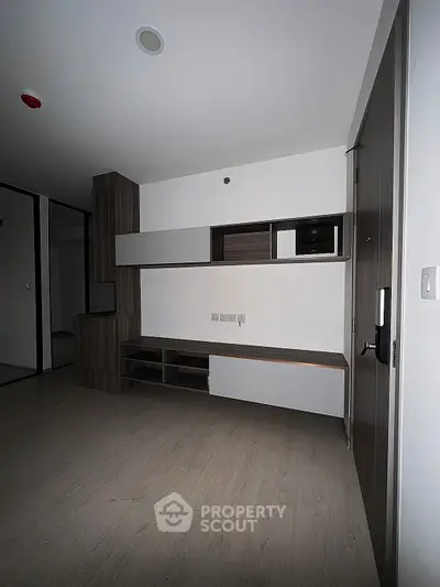 Modern minimalist interior with sleek built-in storage and neutral tones, perfect for urban living.