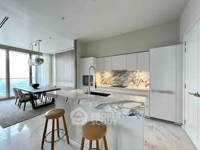 Luxurious modern kitchen with marble countertops and open layout, featuring a dining area with stunning views.
