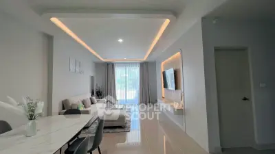Modern living room with sleek design and ambient lighting, featuring a spacious layout and stylish furniture.