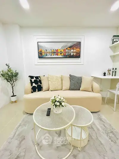 Chic living room with cozy beige sofa, stylish decor, and modern coffee table in a bright, inviting space.