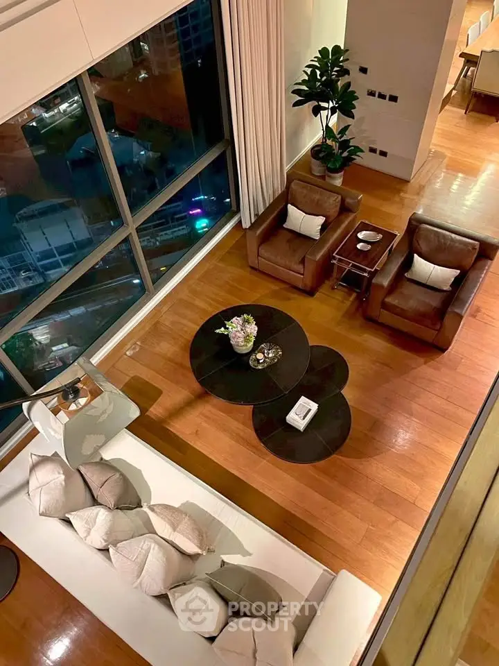 Luxurious high-rise living room with floor-to-ceiling windows and elegant furnishings.