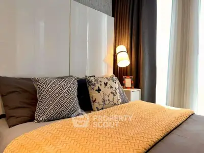 Cozy bedroom with stylish decor and natural light, perfect for relaxation and comfort.