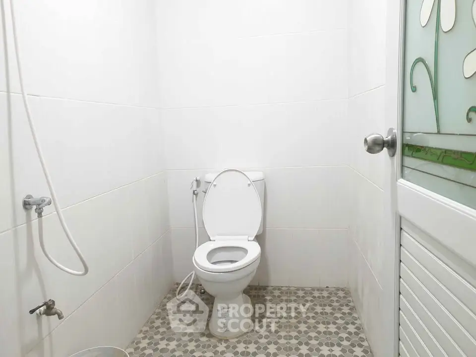 Minimalist bathroom with white tiles and modern fixtures