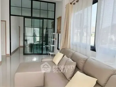 Modern living room with large windows and sleek furniture design