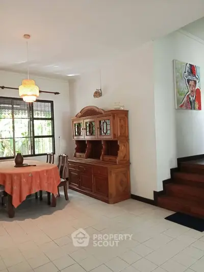Charming dining area with vintage wooden furniture and natural light, perfect for family gatherings.