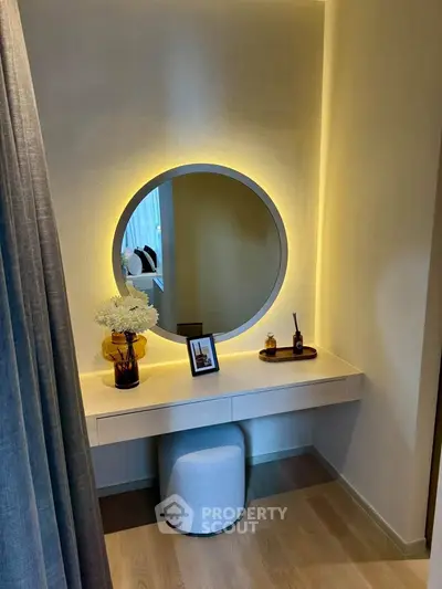 Elegant bedroom vanity with round mirror and ambient lighting