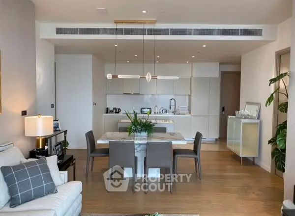 Modern open-plan living room with elegant dining area and sleek kitchen design.