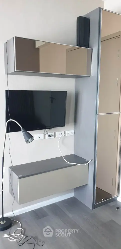 Modern living room with sleek wall-mounted TV and stylish storage units