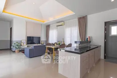Modern open-plan living room with sleek kitchen island and stylish decor