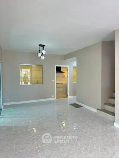 Spacious modern living room with elegant tile flooring and stylish lighting