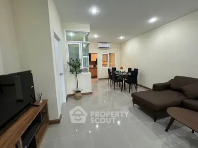 Spacious modern living room with sleek furniture and open layout, perfect for entertaining.