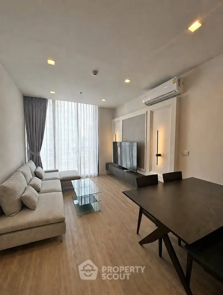Modern living room with sleek furniture and large window in a stylish apartment