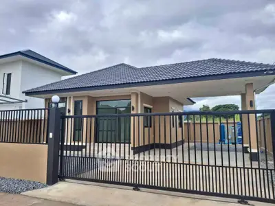 Modern single-story house with gated entrance and stylish roof design, perfect for family living.